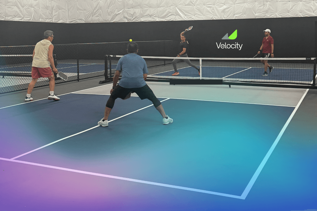 Crowd watching an indoor pickleball match at a Velocity club event